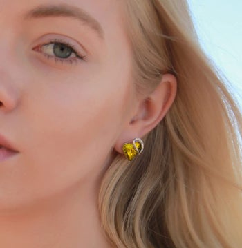 Model wearing the yellow heart earrings