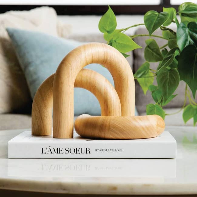 three wooden decorative arches on top of a book
