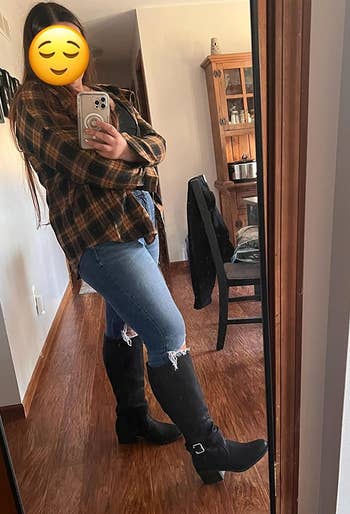 reviewer showing off the extra wide calf boots