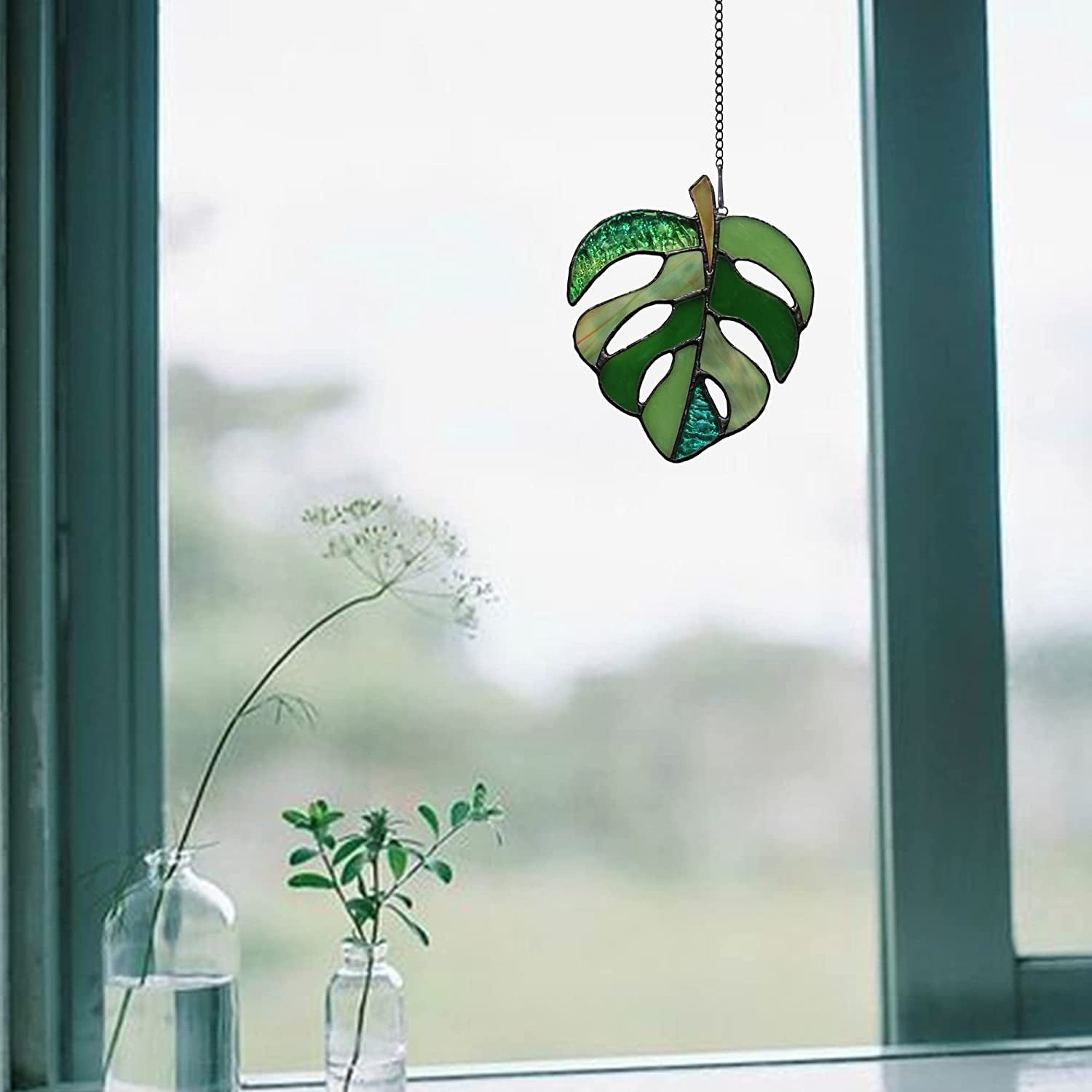 mini stained glass leaf hanging in window 