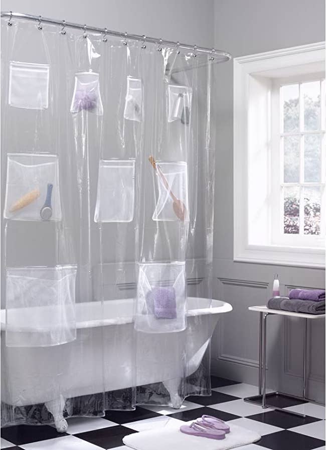 clawfoot bathtub with clear shower curtain organizer
