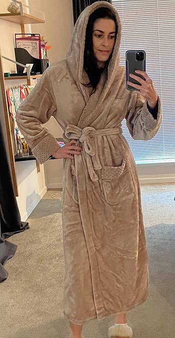 reviewer wearing the tan robe with the hood up