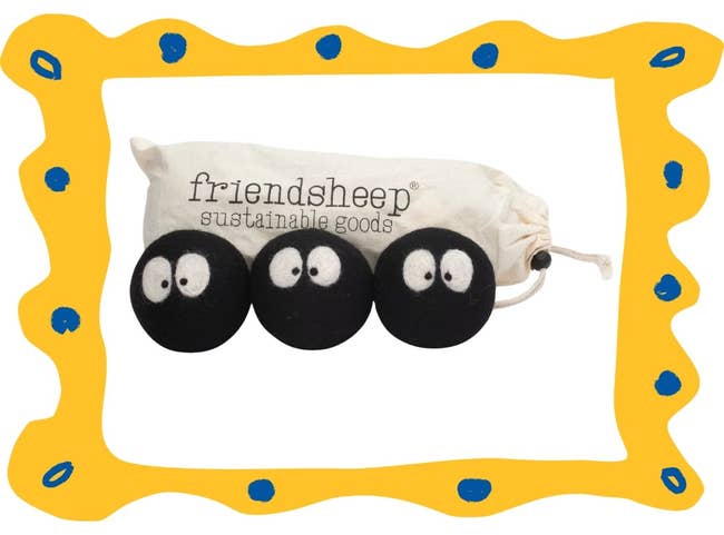 Three black felted wool dryer balls with eyes