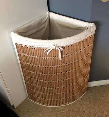 Reviewer image of the brown hamper in a corner