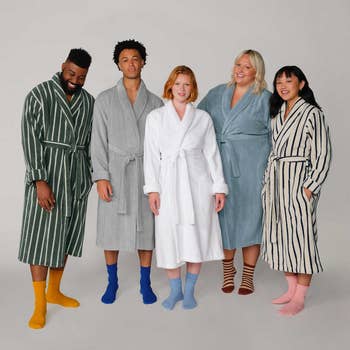 Five models posing successful bathrobes successful antithetic colors and patterns
