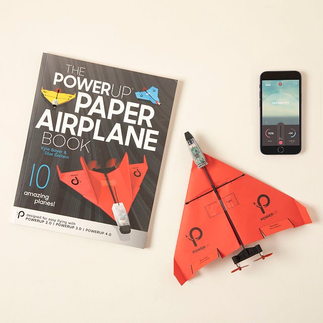 the red paper airplane, a template book, and a smartphone
