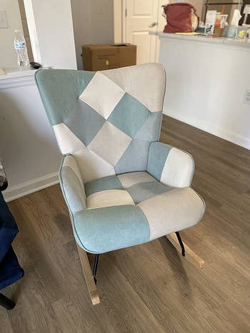 reviewer photo of blue and white patchwork rocking chair in living room