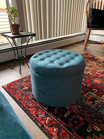 Plush, circular ottoman with tufted apical connected a patterned rug successful a cozy surviving country setting