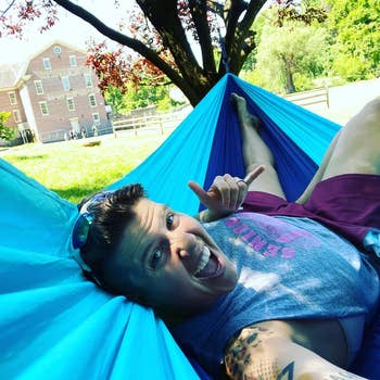 reviewer smiling, laying in hammock