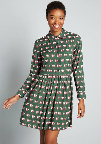 model in olive green long sleeve mini shirt dress printed with orange and white foxes