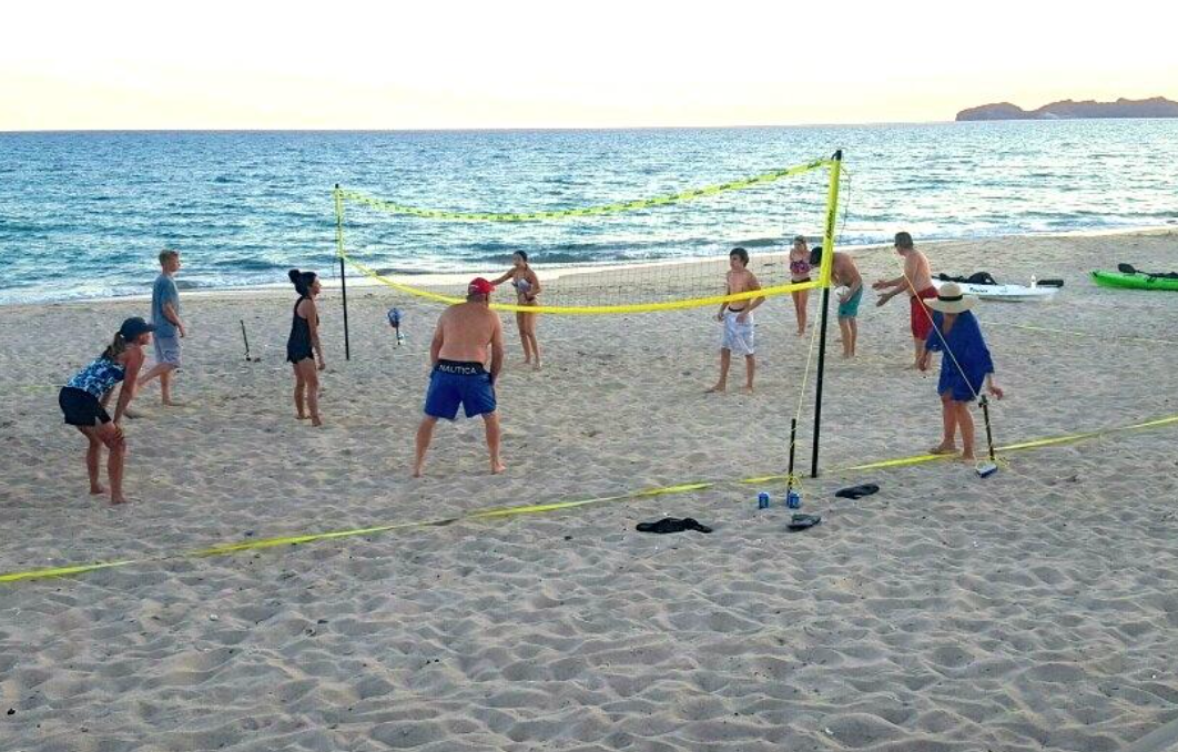 Reviewer photo of several people playing beach volleyball on a beach