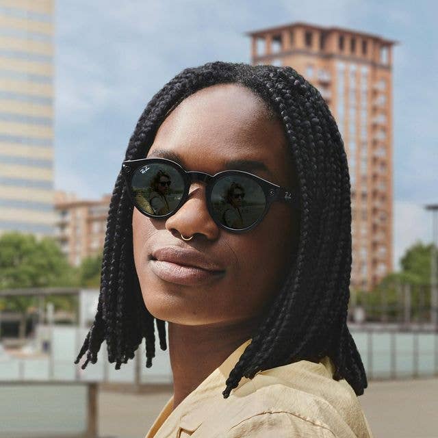 a model wearing the round smart glasses