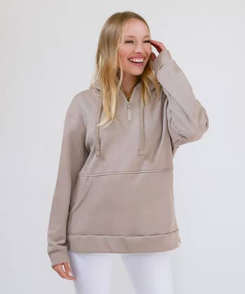 model wearing the beige hoodie