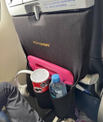 reviewer image of airplane pocket attached to tray and filled with item