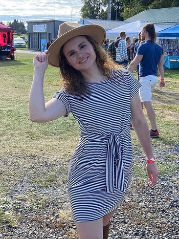 reviewer wearing the navy striped dress