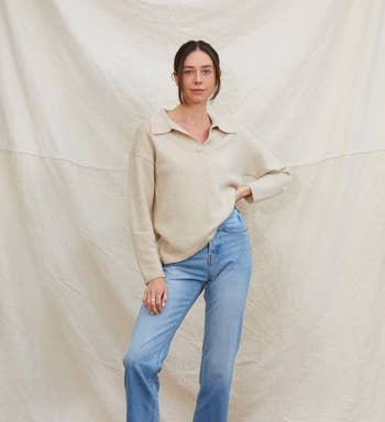 a model wearing the sweater with jeans