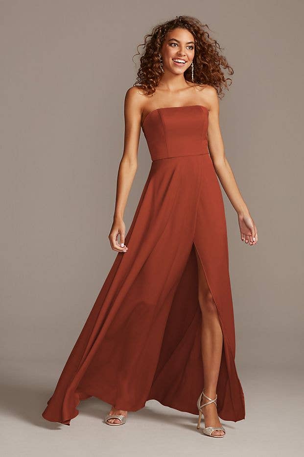 A model wearing the strapless gown in cinnamon 