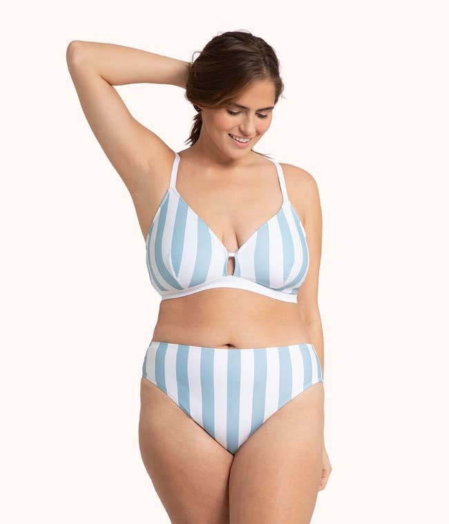 A model in the white and light blue stripe set