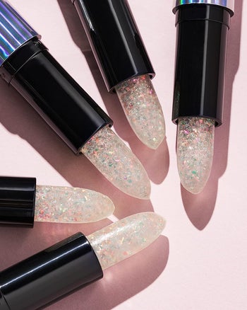 The clear glittery lipstick in its case 