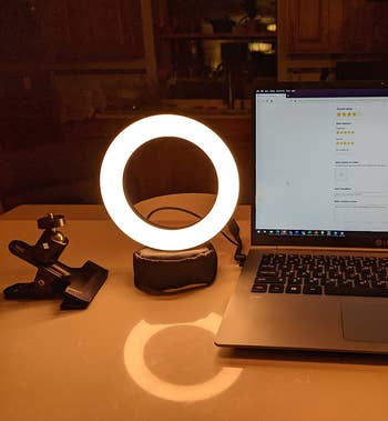 the ring light sitting next to a reviewer's laptop