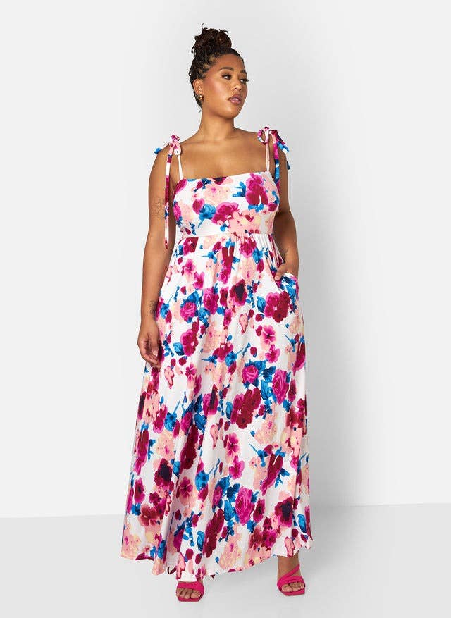 model in a floral dress with tie shoulder straps, ideal for spring shopping
