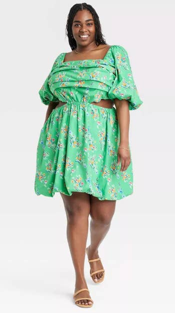 different model wearing the dress in green floral