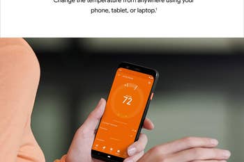 person holding phone showing the nest app