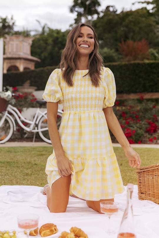 model in yellow and white short sleeve mini dress