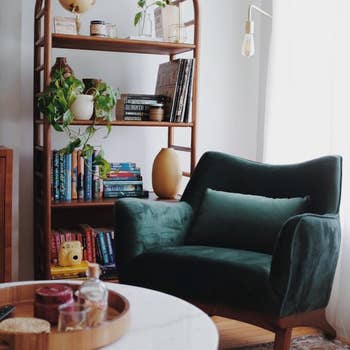 a reviewer's green velvet arm chair