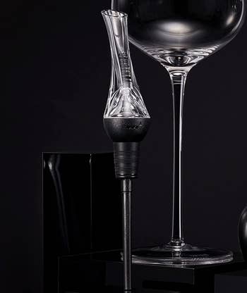 the wine aerator pourer next to a wine glass