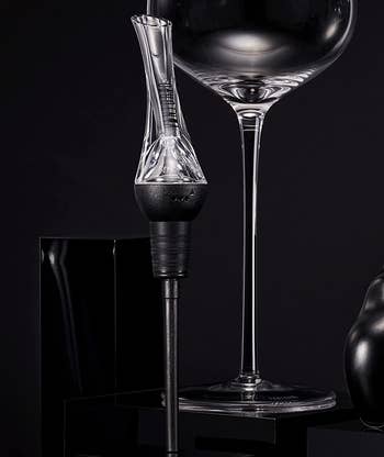 the wine aerator pourer next to a wine glass