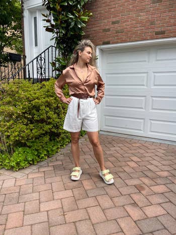 Person successful  a satin blouse and achromatic  shorts, lasting  connected  a ceramic  driveway