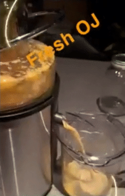 reviewer gif of fresh orange juice coming out of the juicer and into a pitcher