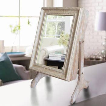 wood mirrored armoire on a desk