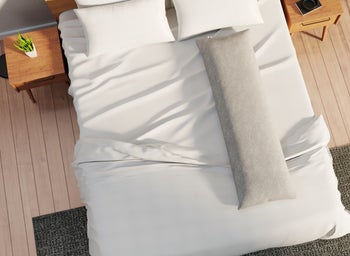 Image of the ivory pillow on a bed