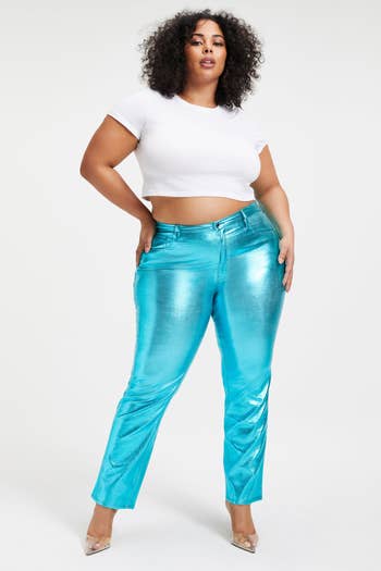 front of a model wearing blue metallic faux leather pants with a white t-shirt