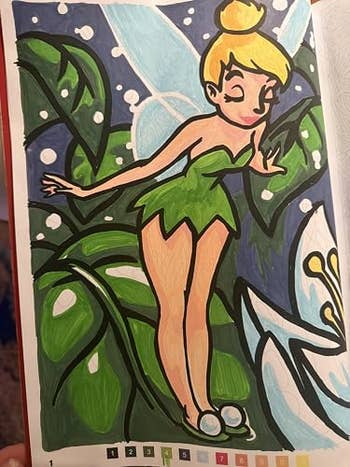 Illustrated fairy with wings wearing a leafage  dress, lasting  among ample  leaves