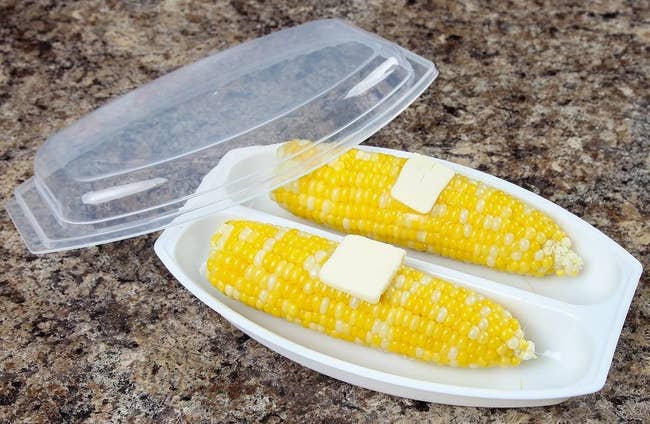 two cobs of corn inside the steamer
