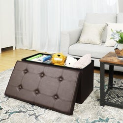 reviewer photo of brown faux leather storage ottoman with children's toys inside