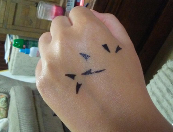 the back of a reviewer's hand showing the winged eyeliner stamp applied 