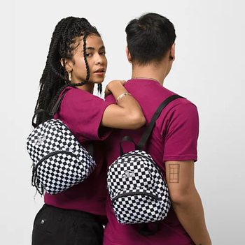 two models wearing checkered mini backpacks