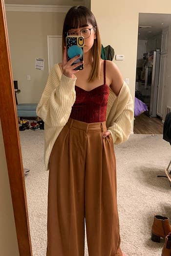 reviewer wearing the brown palazzo pants with a red tank top
