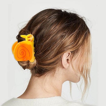 The orange and yellow clip in a model's hair