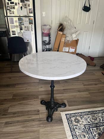 reviewer image of a round table covered in the marble surface cover