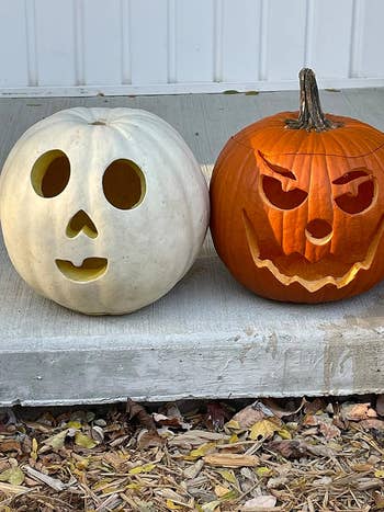 Two pumpkins with faces after using the kit
