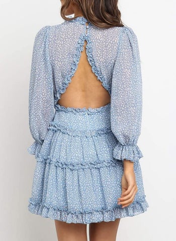 a model showing the back of a dress with a cut out in the back