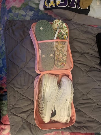 reviewer image showing the show bag open with a pair of sneakers and two pairs of flip flops in it