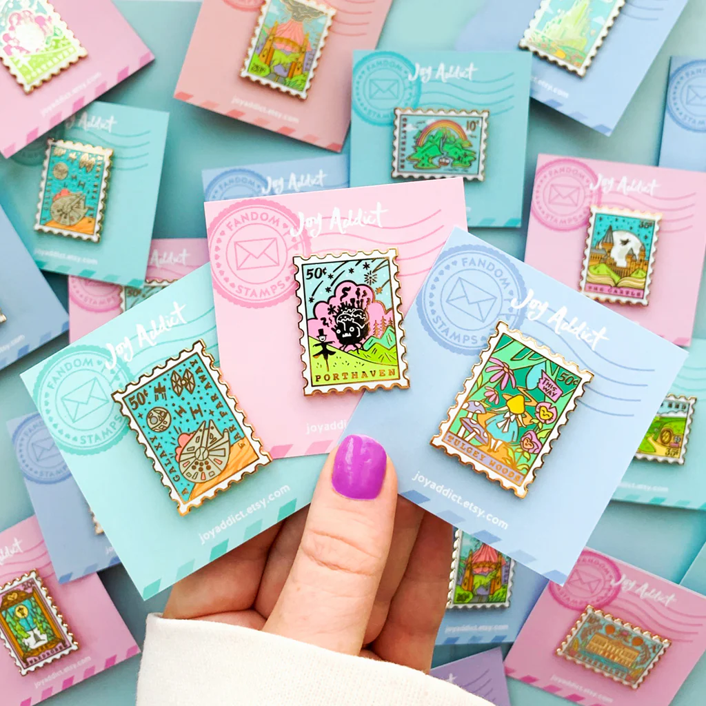 Enamel pins shaped like postage stamps