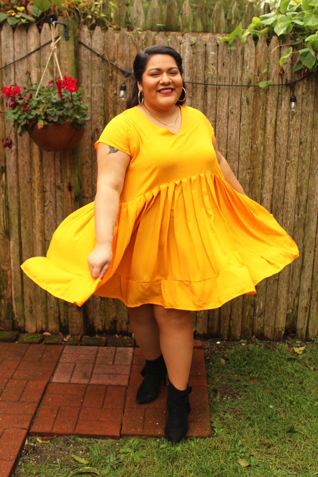model in pleated short sleeve yellow babydoll dress