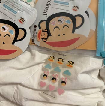 Skincare patches successful playful monkey-shaped packaging featuring assorted cute designs, including clouds, flowers, and hearts. Suitable for brightening and soothing